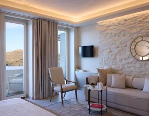 a living room with a couch and a table at Ydor Hotel & Spa by Sandglass in Vourkari