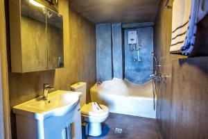 a bathroom with a sink and a tub and a toilet at Sunrise Suite in Kavála +11 photos