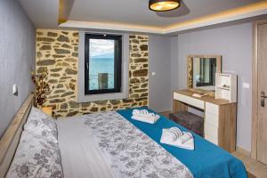 a bedroom with a bed and a sink and a window at Sunrise Suite in Kavála