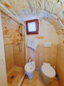 a bathroom with a toilet and a sink at B&B La Rosa dei Trulli Alberobello in Alberobello +32 photos