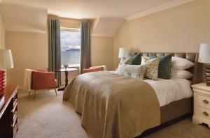 a bedroom with a large bed and a window at Butler Arms Hotel in Waterville +22 photos
