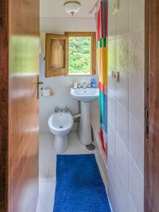 a bathroom with a sink and a toilet and a window at Casa Mare e Sole in Vibonati