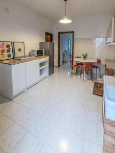 a kitchen and dining room with a table and chairs at Casa Mare e Sole in Vibonati +35 photos