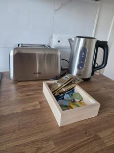 a box of food sitting on a counter next to a toaster at L'Escale de la Râperie logement 4 in Tincourt-Boucly