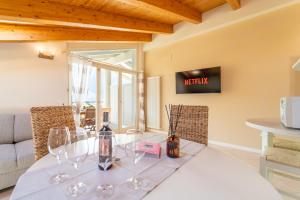 a dining room with a table with wine glasses on it at The A-LINE Lake COMO view apt A with pool & garage in Tremezzo