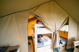 a person in a tent in a bunk bed at Gran Camping Zarautz in Zarautz