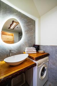a bathroom with a sink and a washing machine at Cesa Balzan in Canazei +113 photos
