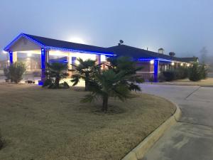 a building with blue lights on the front of it at Redwood Inn - White Hall in White Hall