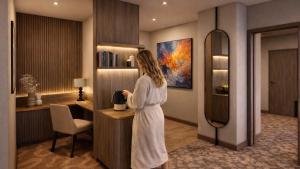 a woman is standing in a hotel room at Strand Öland in Borgholm
