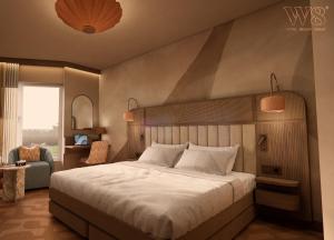 a bedroom with a large bed and a chair at Strand Öland in Borgholm