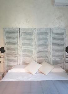 a large white bed with two pillows on it at La Locanda dell'Angelo in Rome