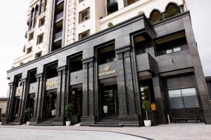 a store front of a tall building withwindows at Mustafa Hotel in Samarkand