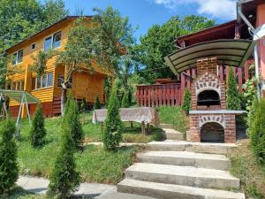 a house with a brick oven in the yard at Relaxare in Sohodol, Alba in Sohodol