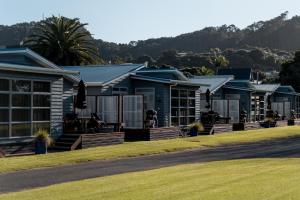 a row of houses with a lawn in front at Tasman Holiday Parks - Hahei Beach in Hahei