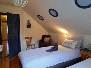 a bedroom with a bed with a blue robe on it at Elvebakk Bed & Breakfast in Reed +41 photos