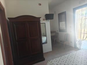 a bedroom with a bed and a dresser and a mirror at Gli Ulivi Residence in Leverano