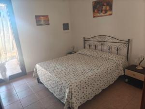 a bedroom with a bed with a patterned bedspread at Gli Ulivi Residence in Leverano