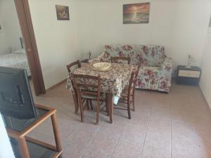 a living room with a table and a couch at Gli Ulivi Residence in Leverano