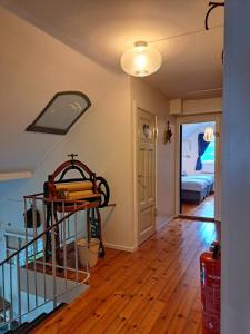 a living room with a staircase and a bedroom at Elvebakk Bed & Breakfast in Reed