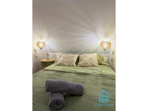 a bedroom with a bed with a towel on it at Casa Verde Apartment at Old Town Gdańsk in Gdańsk