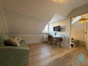 a living room with a couch and a table at Casa Verde Apartment at Old Town Gdańsk in Gdańsk