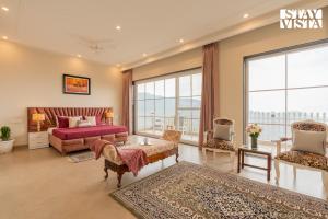 a living room with a bed and a couch at StayVista at IRIS with Outdoor Pool & Bonfire in Dagshai +38 photos