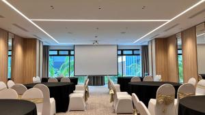 a conference room with tables and chairs and a screen at The Federal Kuala Lumpur in Kuala Lumpur +34 photos