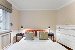 a bedroom with a white bed with two night stands at Haus Meerblick in Rantum