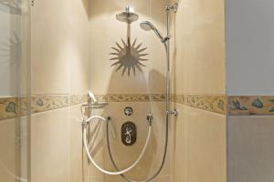 a shower in a bathroom with a spider on the wall at Haus Meerblick in Rantum +29 photos