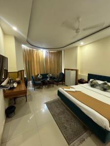 a hotel room with a bed and a living room at Barog Heights in Barog