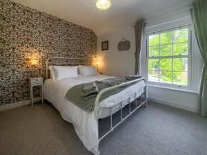 a bedroom with a bed and a window at Little Tern in Snettisham
