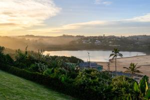 a view of a river with a city in the background at Shabby View Beach House in Southbroom