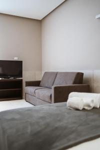 a living room with a couch and a television at MEANDRI Apartment in San Severo