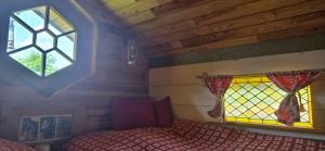 a bedroom with a bed and a window at Nuit insolite, repas autour du feu piscine sauna jaccuzi in Azerailles