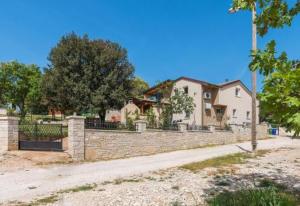 a brick fence in front of a house at Apartments Salak in Pula