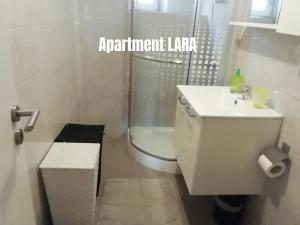 a bathroom with a toilet and a sink and a shower at Apartments Salak in Pula +37 photos