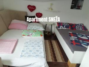 a bedroom with a white bed with pillows at Apartments Salak in Pula