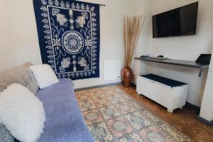 a living room with a couch and a tv at Rustic Butler B&B in White River