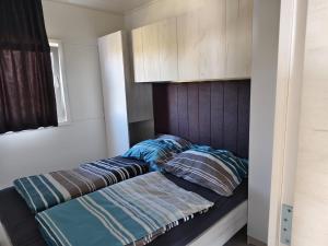 a bed with two pillows on it in a bedroom at GF Mobilehomes Kroatien in Drage +86 photos
