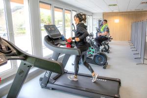 a woman running on a treadmill in a gym at Gran Camping Zarautz in Zarautz +33 photos