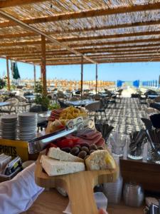 a tray of food on a table with bread and fruit at Elite Hotel in Golem
