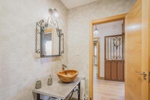 a bathroom with a wooden bowl sink on a counter at El Trillo in Marlín +23 photos