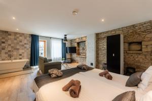 a bedroom with a large bed with towels on it at Johan Suites & Spa in Kuressaare +89 photos