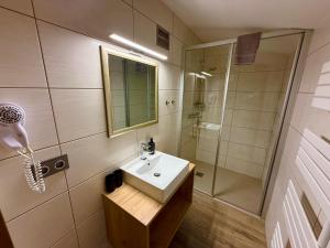 a bathroom with a sink and a shower at Pension Marina in Tux +42 photos