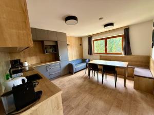 a kitchen with a table and a dining room at Pension Marina in Tux