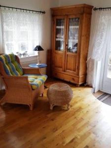 a living room with a couch and a chair at Kapitänshaus, Hausteil in Oevenum +9 photos