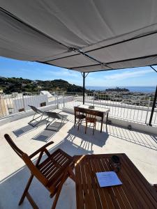 a patio with a table and chairs under a canopy at Holiday Home Tarinuzza in Lipari