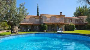 a large swimming pool in front of a house at Alilea in Politika