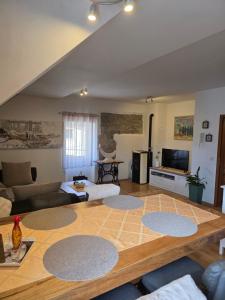 a large living room with a large wooden floor at Apartman Gorski raj in Fužine