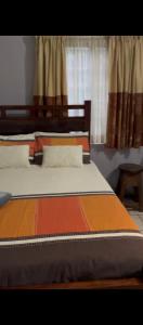 a bedroom with two beds and a window at 1054 Holiday Home in Kasane Airport